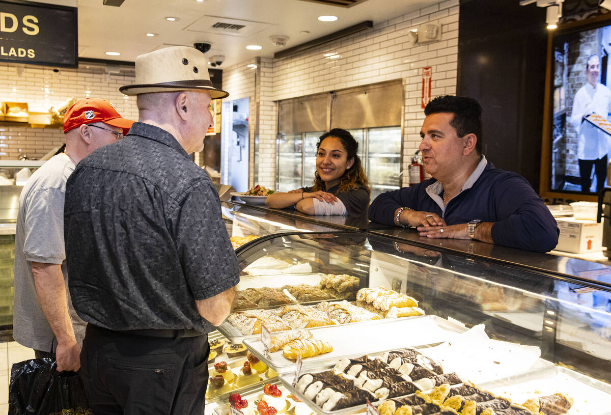 Buddy Valastro, right, star of TLC's "Cake Boss," talks to his customers at his Boss Cafe at Th ...