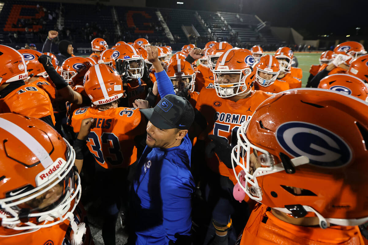 Bishop Gorman head coach Brent Browner huddles with players after defeating Desert Pines in a C ...