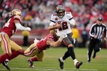 Tampa Bay Buccaneers quarterback Tom Brady (12) runs against San Francisco 49ers defensive end ...