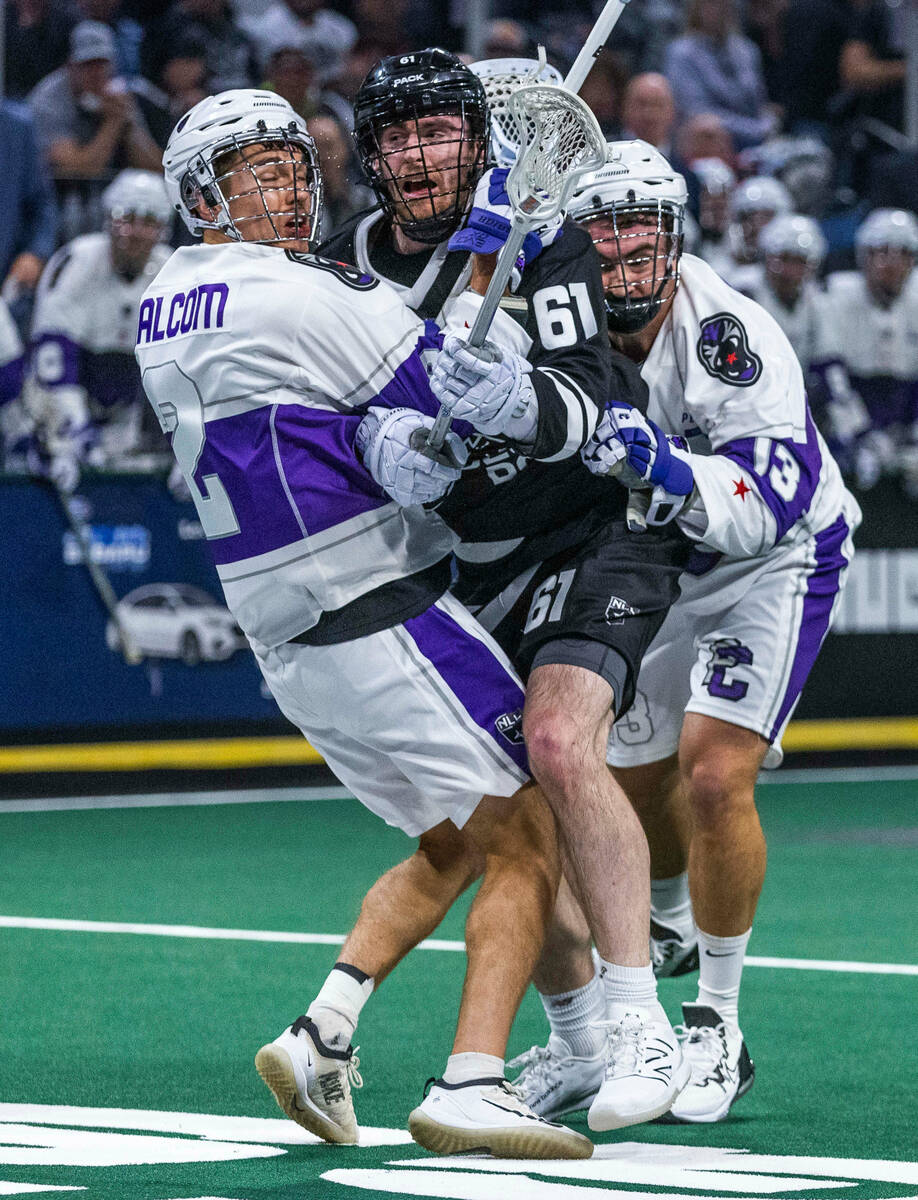 Desert Dogs forward Charlie Bertrand (61) is hit from both sides on a drive to the goal by Pant ...