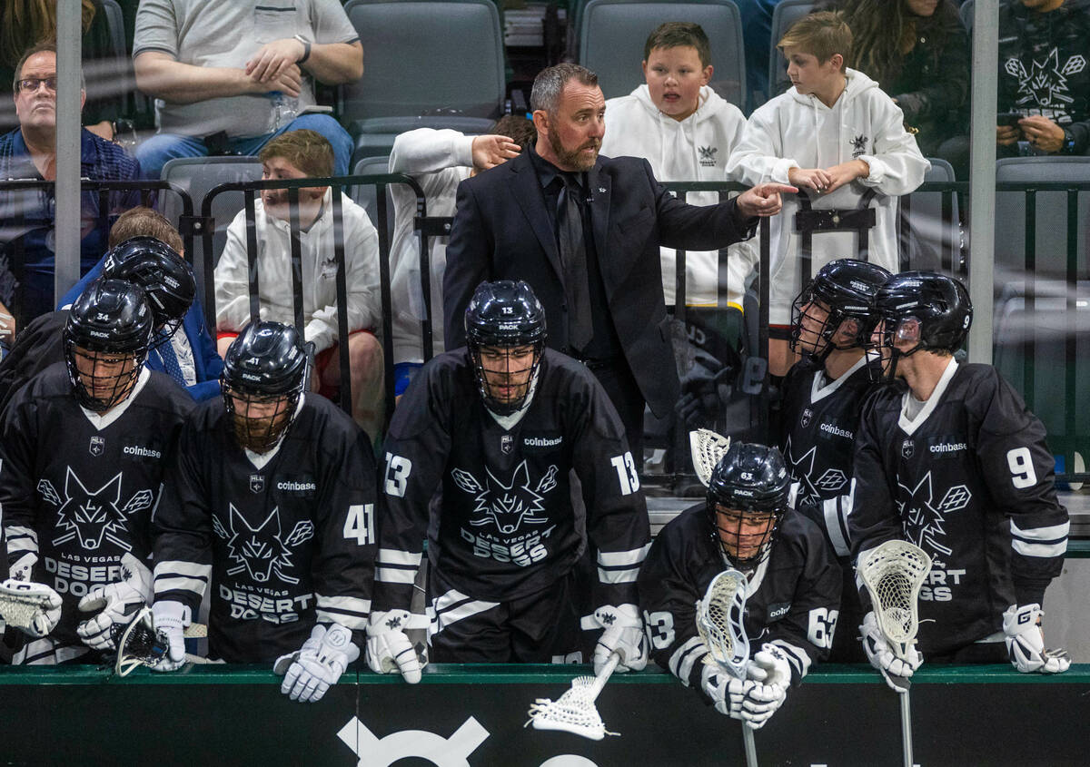 Desert Dogs head coach Shawn Williams talks with players on the bench versus Panther City durin ...
