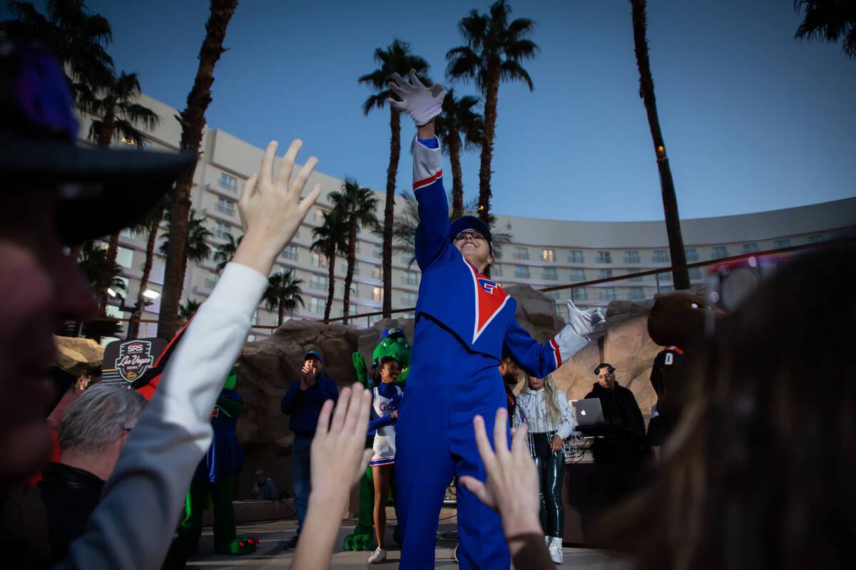 Madison Cross, University of Florida marching band member, throws out free t-shirts during a pe ...
