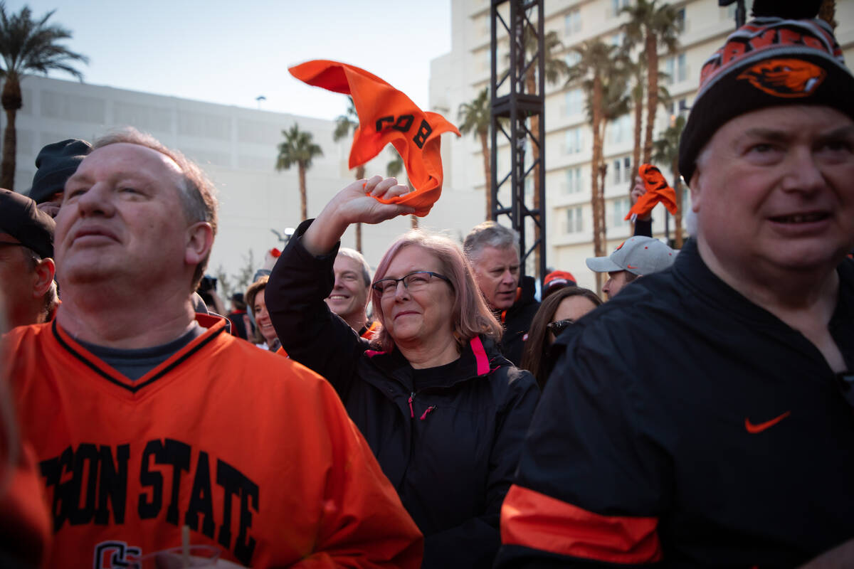 Theresa Arnold waves her Oregon State University flag during a pep rally for both University o ...