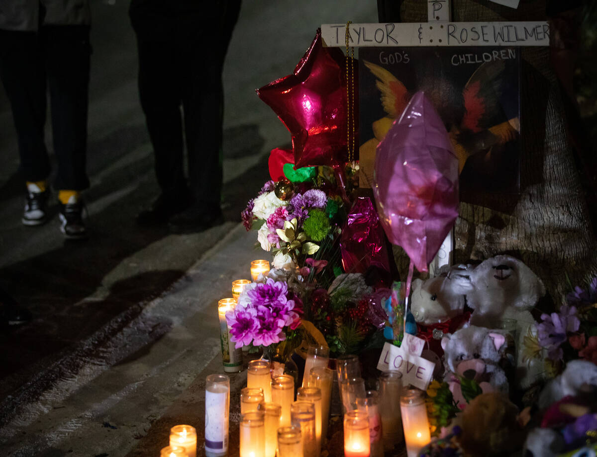 A candlelight vigil is held by neighbors for Taeylr and Rose Wilmer at the site of the fatal ca ...