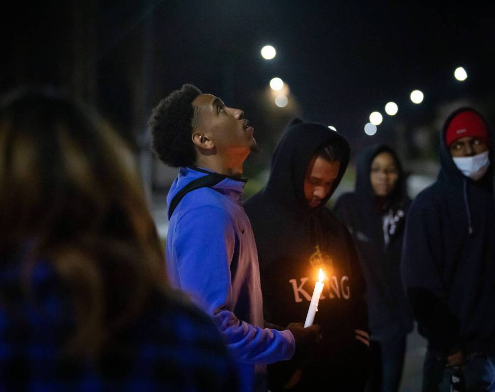 Tavon Wilmer, 22, holds a candle during a candlelight vigil for his daughters, Taeylr and Rose ...
