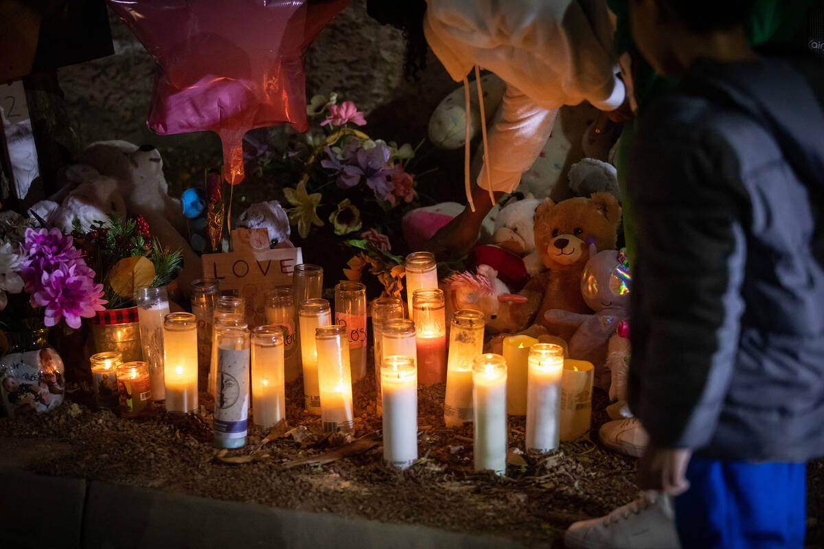 A candlelight vigil is held by neighbors for Taeylr and Rose Wilmer on Saturday, Dec. 17, 2022 ...