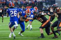 Florida Gators punter Jeremy Crawshaw (26) has a kick blocked into teammate Florida Gators tigh ...