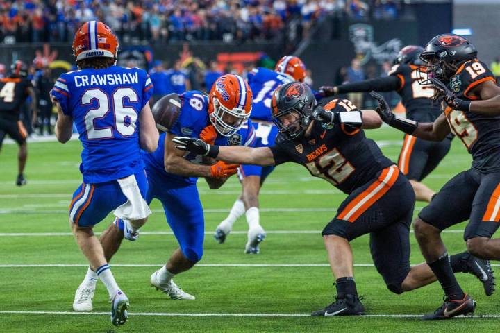 Florida Gators punter Jeremy Crawshaw (26) has a kick blocked into teammate Florida Gators tigh ...