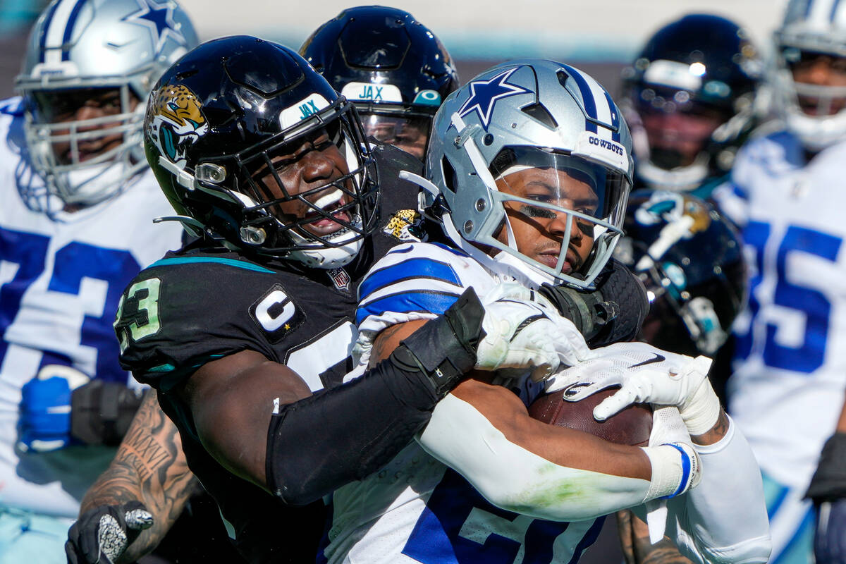 Jacksonville Jaguars linebacker Foyesade Oluokun (23) tackles Dallas Cowboys running back Tony ...