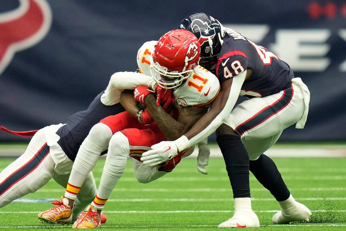 Kansas City Chiefs wide receiver Marquez Valdes-Scantling (11) is hit by Houston Texans cornerb ...