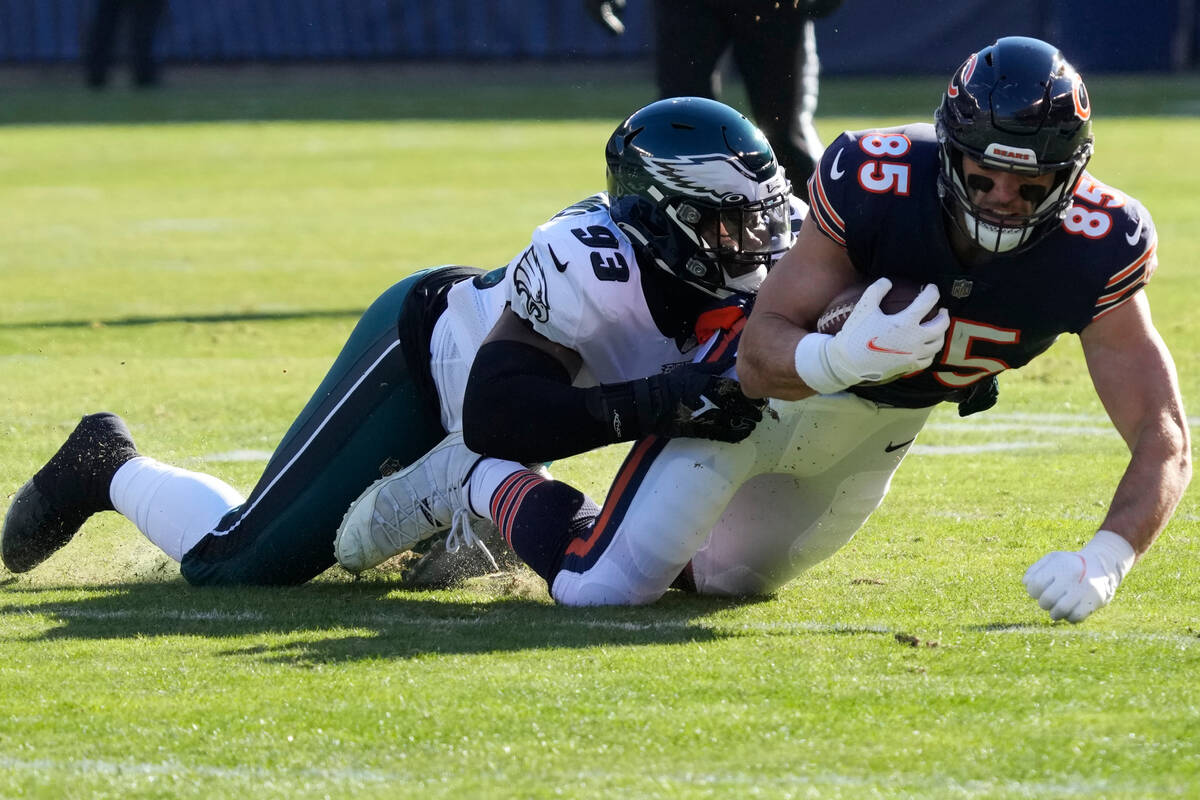 Chicago Bears' Cole Kmet, right, is tackled by Philadelphia Eagles' Milton Williams during the ...