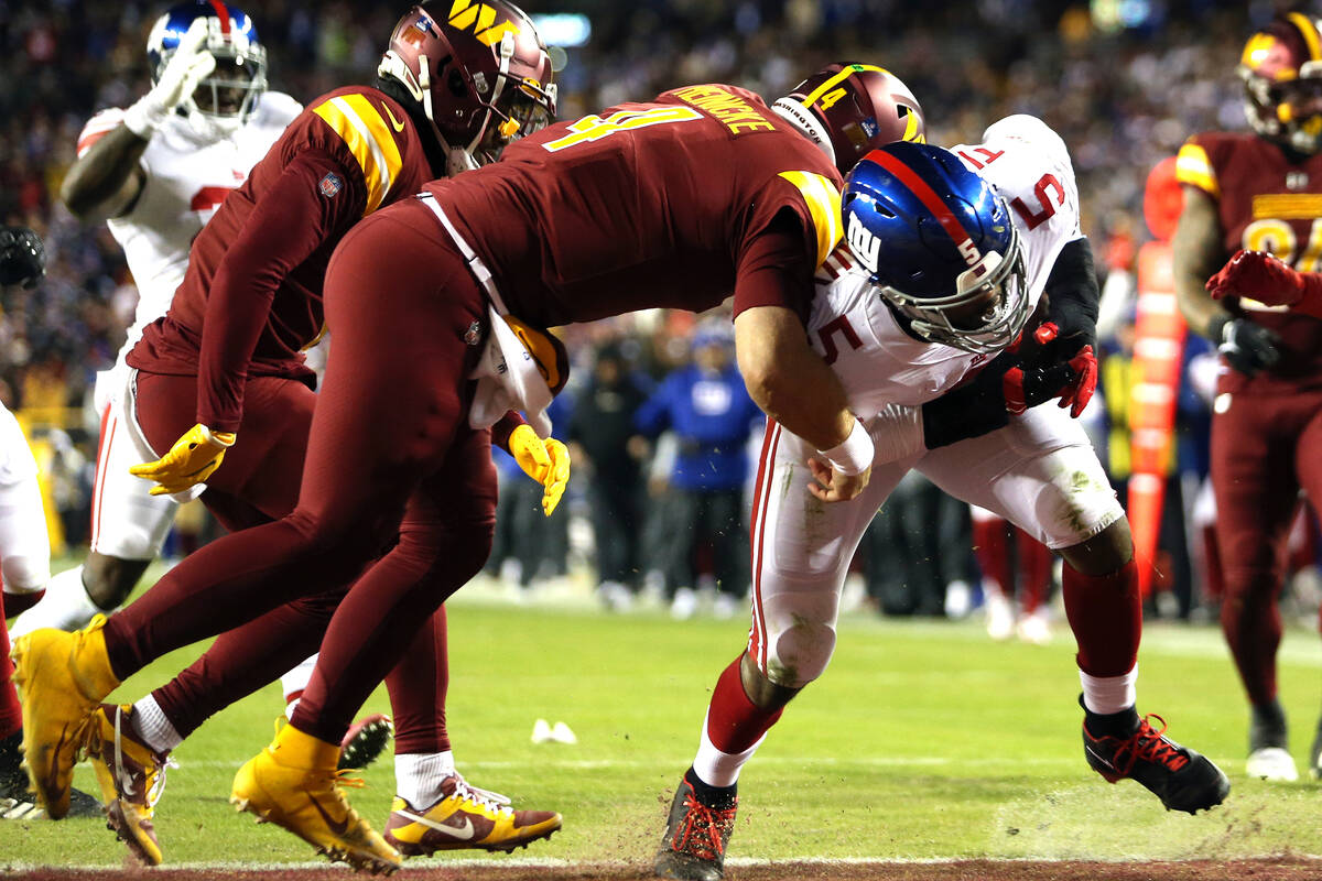 New York Giants defensive end Kayvon Thibodeaux (5) scores a touchdown during an NFL football g ...