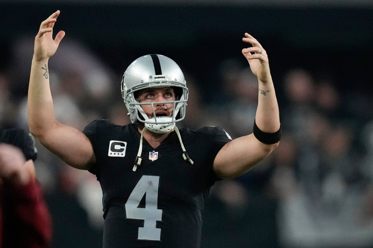 Las Vegas Raiders quarterback Derek Carr reacts after a play under review was called a touchdow ...