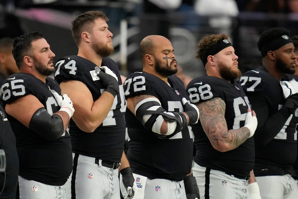 Las Vegas Raiders stand for the national anthem during the first half of an NFL football game b ...
