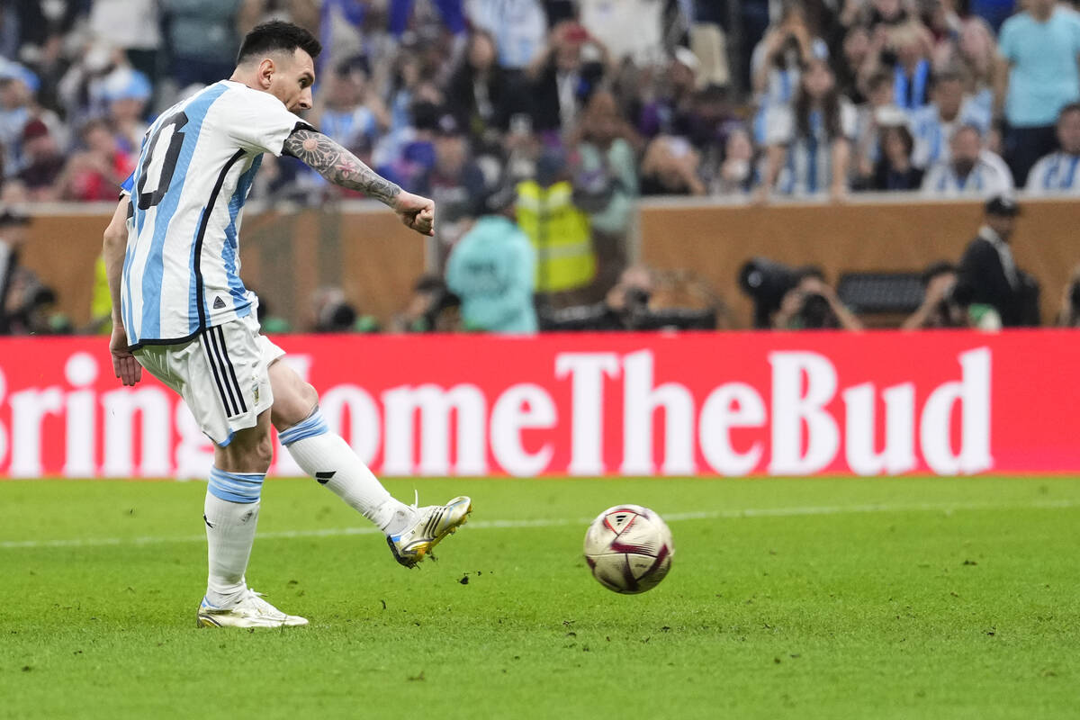 Argentina's Lionel Messi scores his side's opening goal during the World Cup final soccer match ...