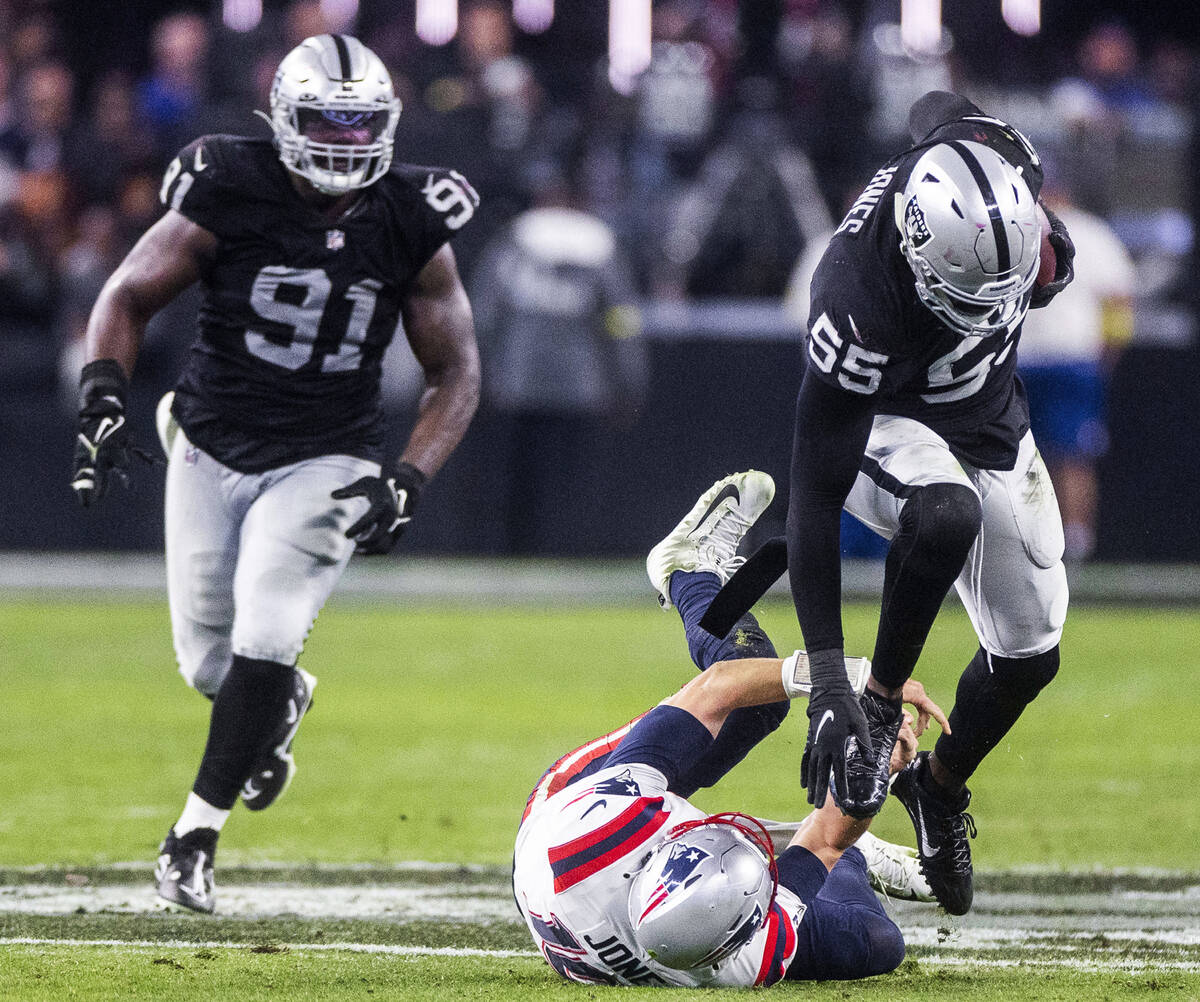 Raiders defensive end Chandler Jones (55) dives New England Patriots quarterback Mac Jones (10) ...