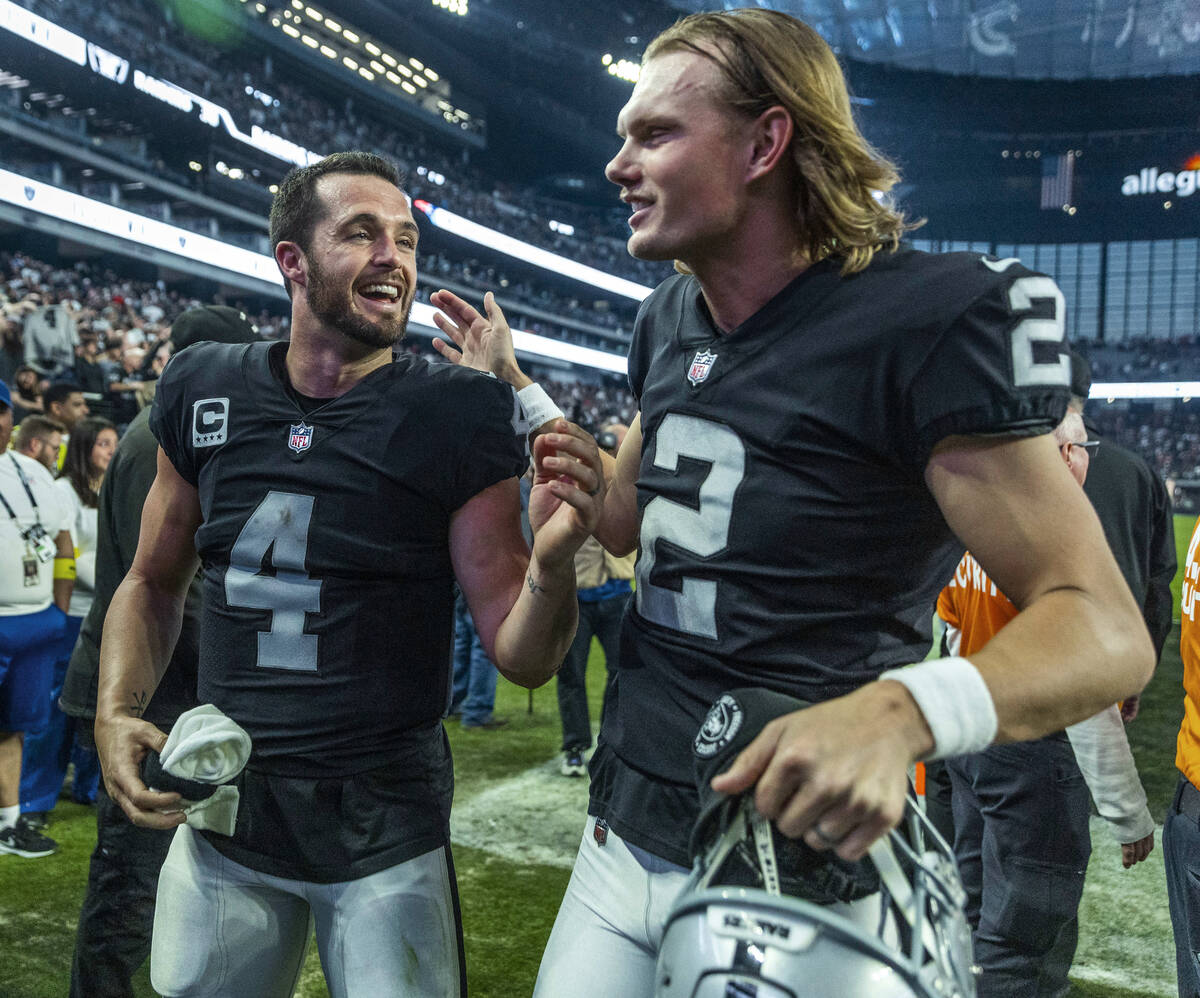 Raiders quarterback Derek Carr (4) and Raiders place kicker Daniel Carlson (2) celebrate after ...