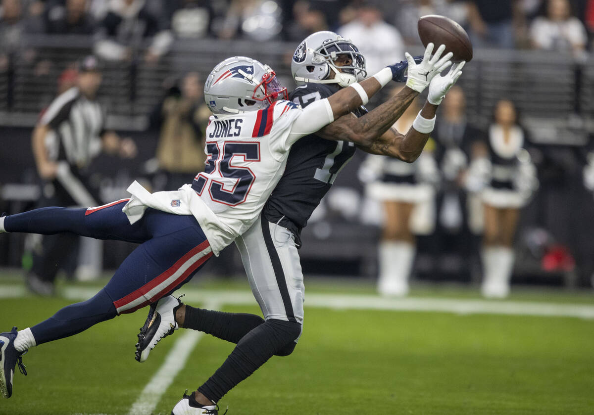 New England Patriots cornerback Marcus Jones (25) defends a pass intended for Raiders wide rece ...