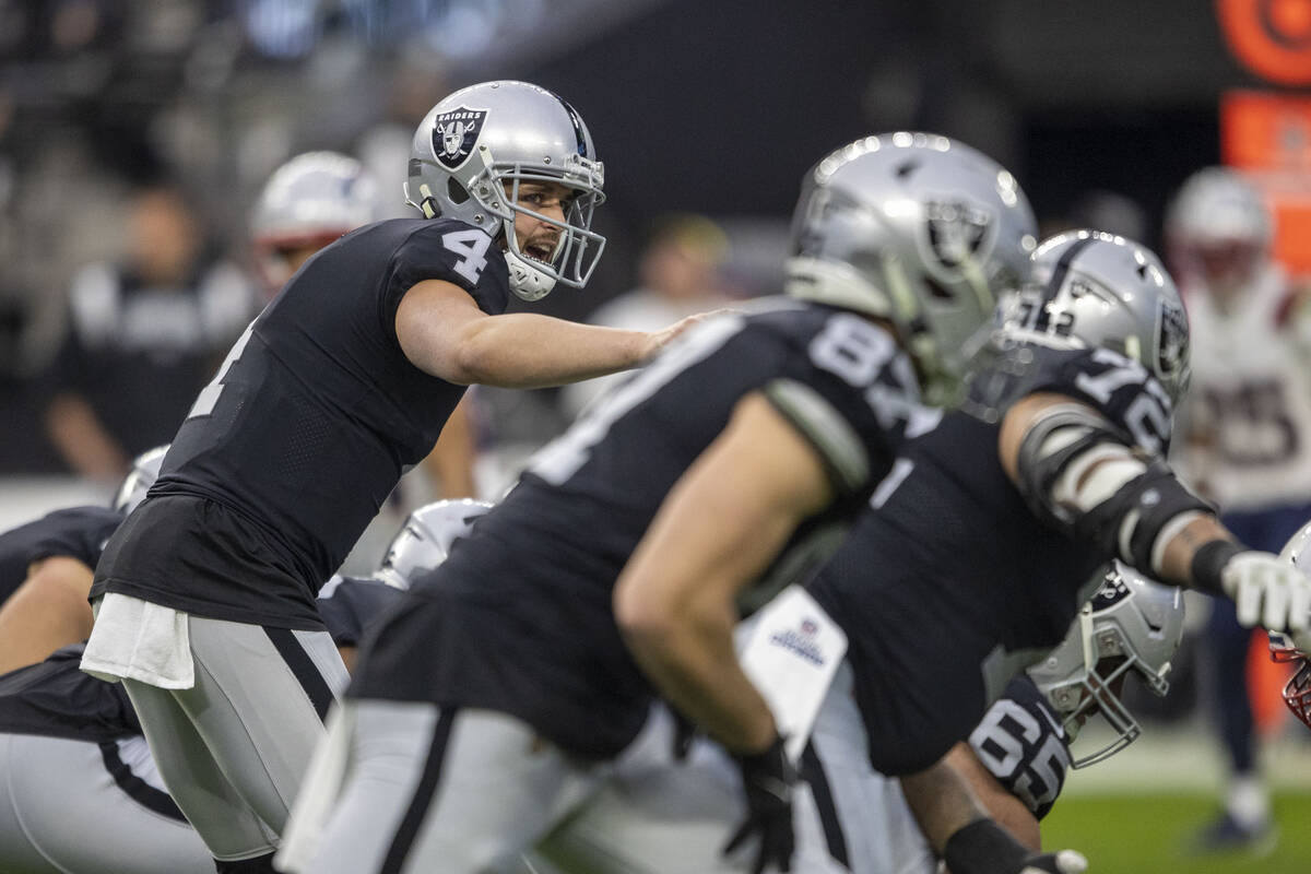 Raiders quarterback Derek Carr (4) audibles at the line of scrimmage during the first half of a ...