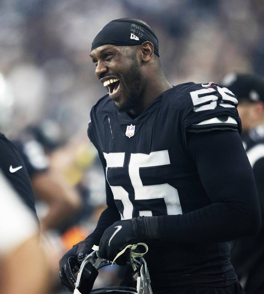 Raiders defensive end Chandler Jones (55) laughs on the sideline during halftime of an NFL game ...