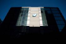 FILE - A Twitter logo hangs outside the company's San Francisco offices on Tuesday, Nov. 1, 202 ...