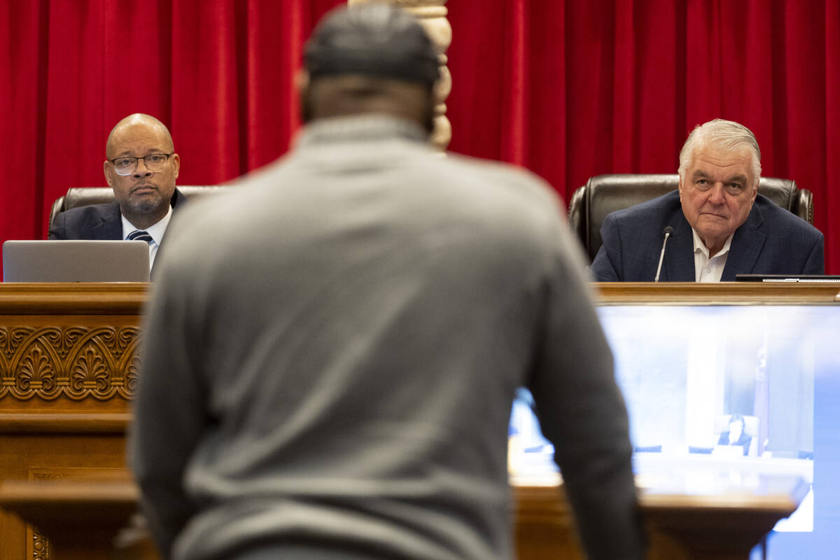 Nevada Attorney General Aaron Ford, left, and Gov. Steve Sisolak, listen to former Nevada death ...