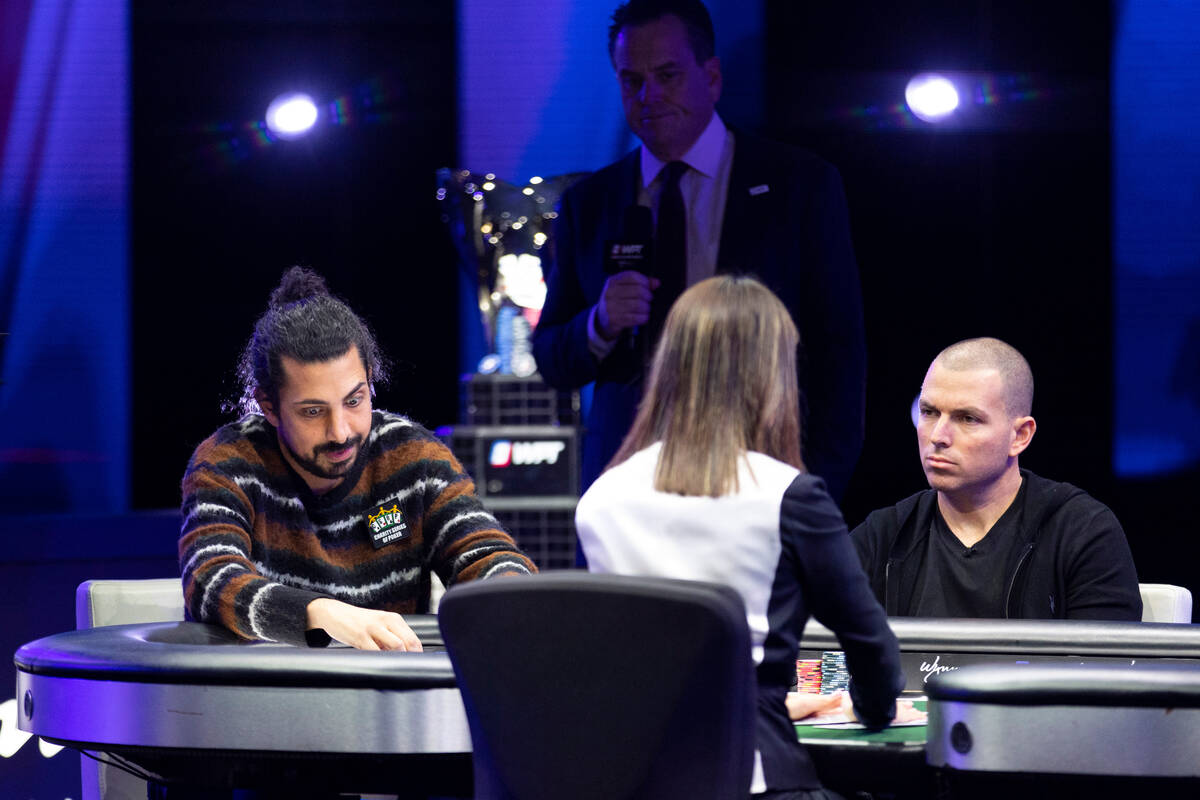 Jean-Claude Moussa, left, and Adam Adler, react after a play in the final table of the World Po ...