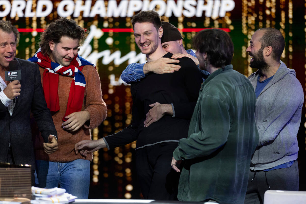 Eliot Hudon, center, celebrates his win in the final table of the World Poker Tour World Champi ...