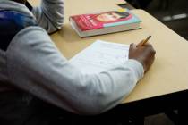 A sixth grade student writes down math problems during class at Democracy Prep in Las Vegas, on ...