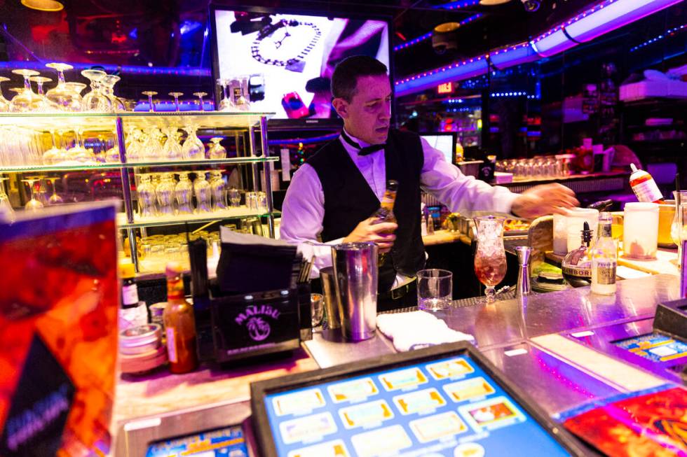 Bartender Kyle Tomsic makes a drink in the Fireside Lounge at Peppermill on Tuesday, Dec. 13, 2 ...