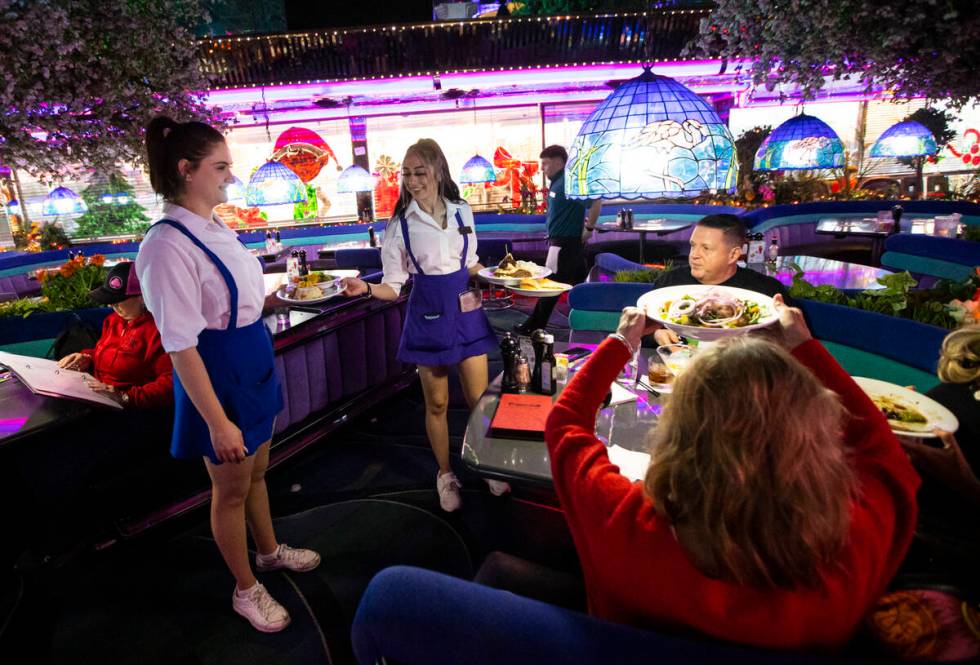 Waitresses Haleigh Bilesimo, left, and Marilyn Velez bring out dishes to diners at Peppermill o ...