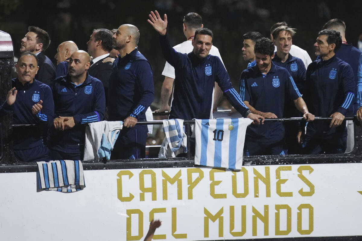 Coach Lionel Scaloni waves upon the arrival of the Argentine soccer team that won the World Cup ...