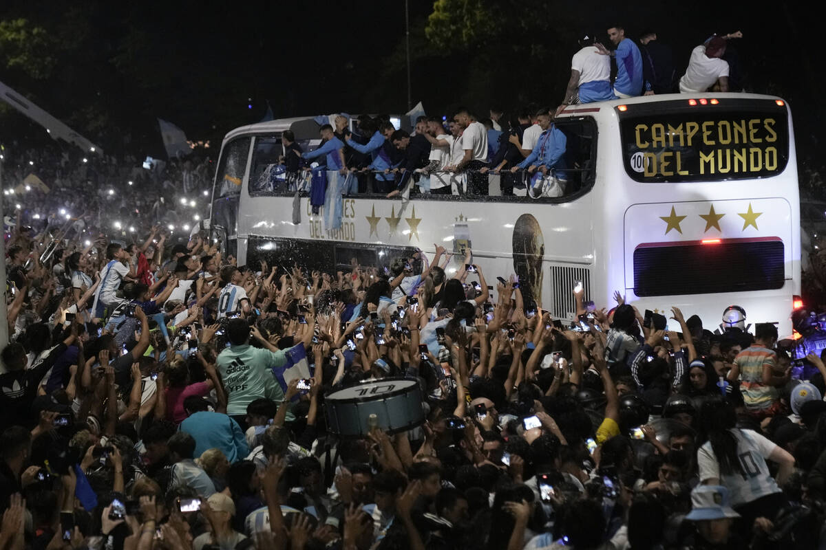 Fans welcome home the players from the Argentine soccer team that won the World Cup after they ...