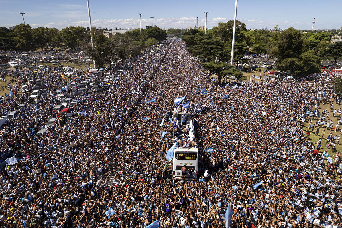 The Argentine soccer team that won the World Cup title ride on an open bus during their homecom ...