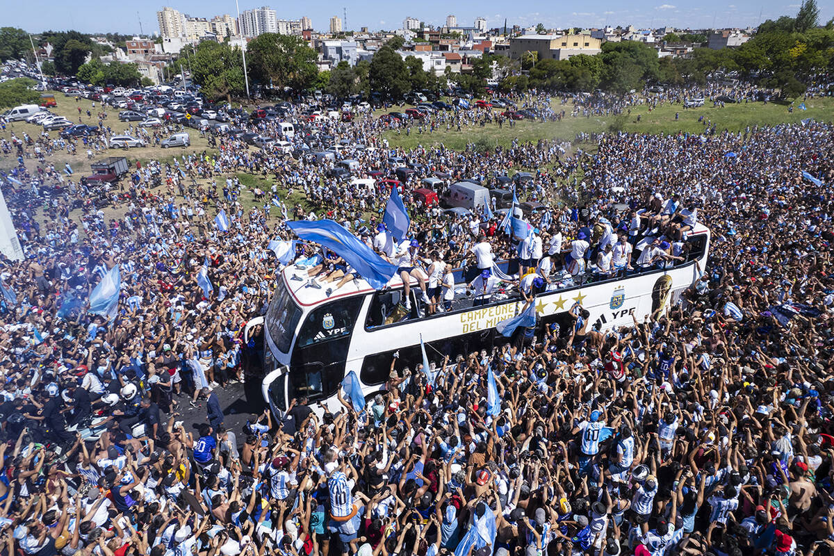 The Argentine soccer team that won the World Cup title ride on an open bus during their homecom ...