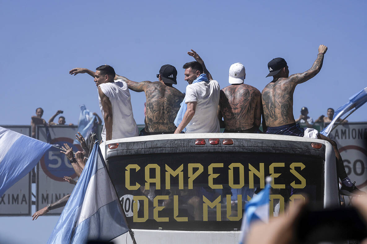 Lionel Messi, center and teammates wave from an open top bus driving the soccer team that won t ...