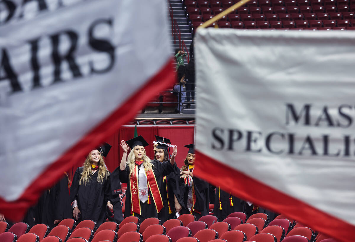 Students wave to their families at the UNLV graduate degree graduation ceremony at the Thomas & ...