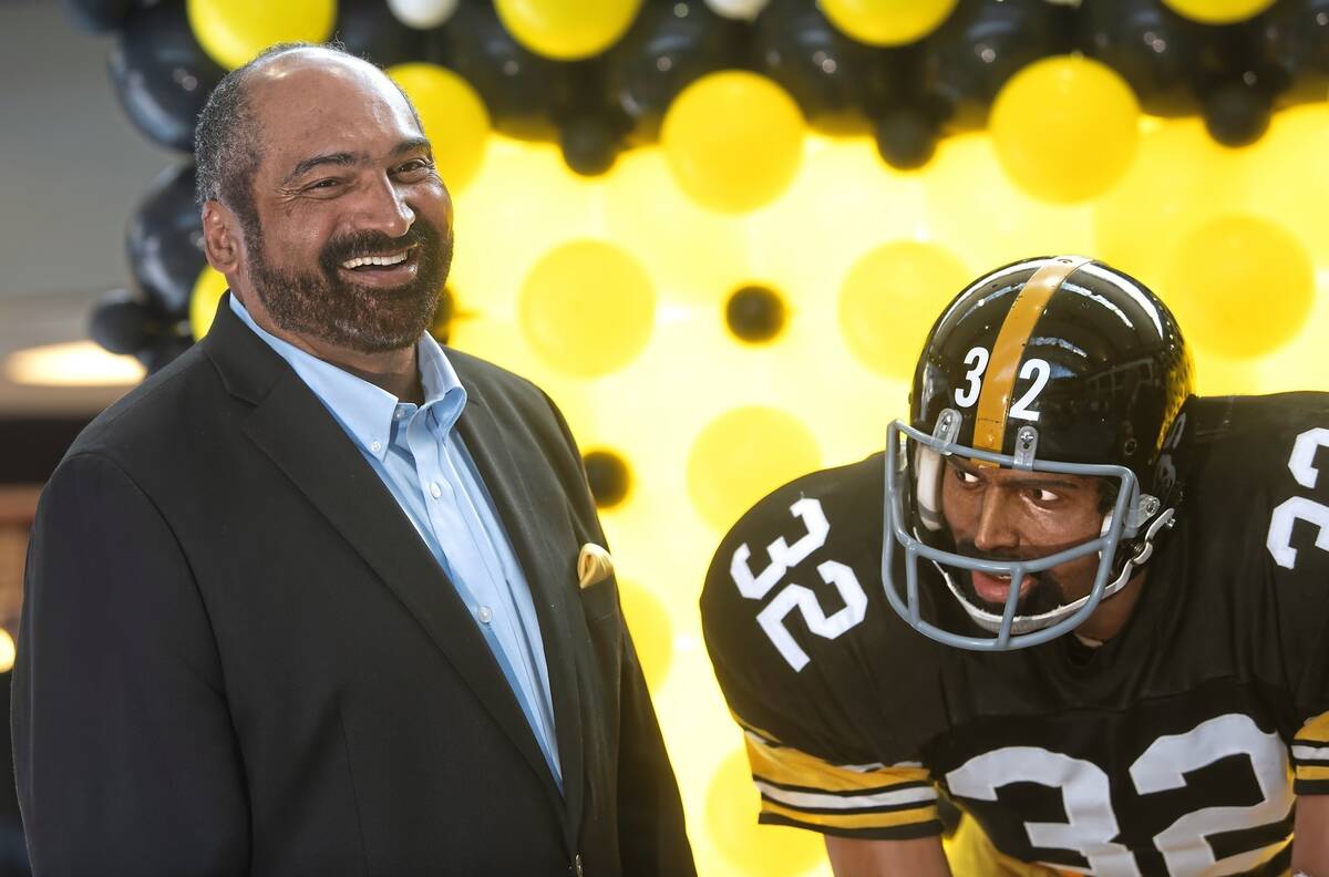 FILE - Former Pittsburgh Steelers running back Franco Harris stands next a statute of himself o ...