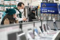 FILE - Signs advertise deals and low prices at a Walmart in Secaucus, N.J., Tuesday, Nov. 22, 2 ...