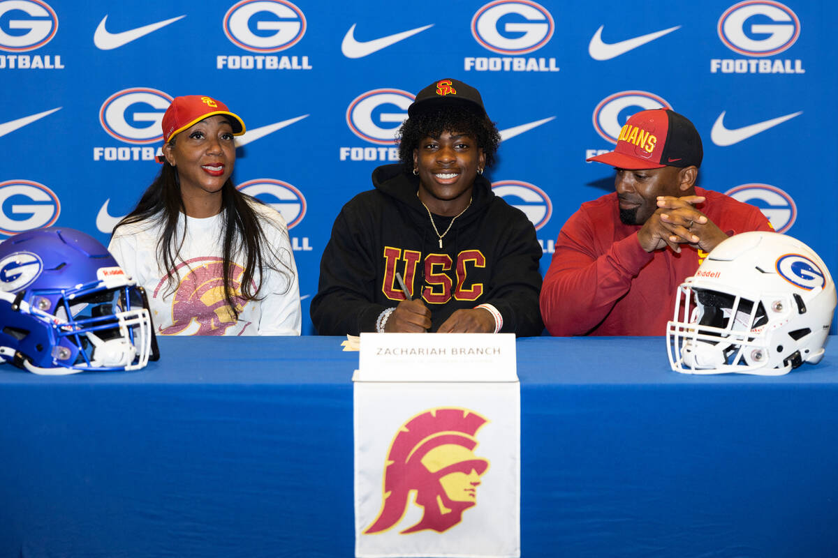 Zachariah Branch, center, committed to the University of Southern California, with his mother R ...
