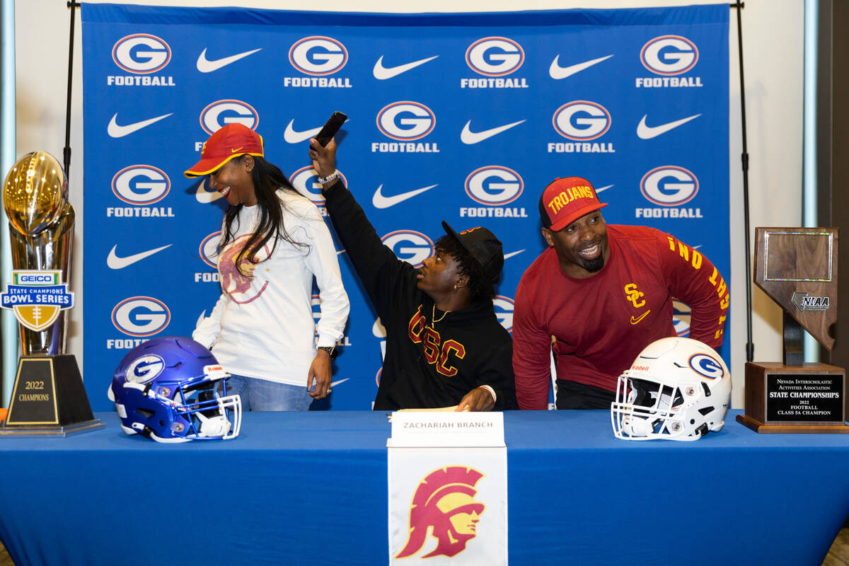 Zachariah Branch, center, committed to the University of Southern California, with his mother R ...