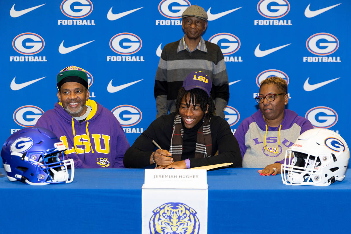 Jeremiah Hughes, center, committed to the Louisiana State University, with his father from left ...