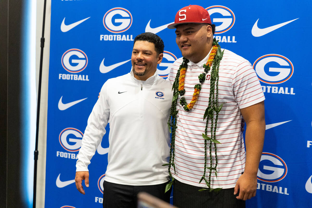 Zak Yamauchi, right, committed to Stanford University, with football head coach Brent Browner, ...