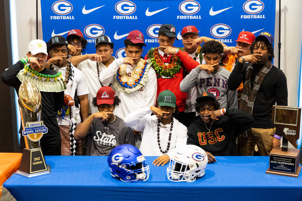 Students and football players pose during the National Signing Day event at Bishop Gorman High ...