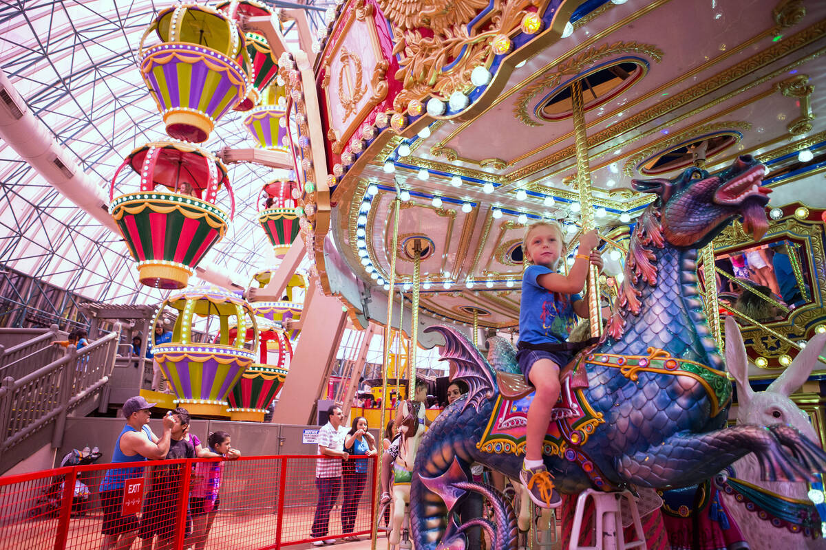 Children ride the carousel at the Adventuredome Theme Park inside Circus Circus on Friday, Aug. ...