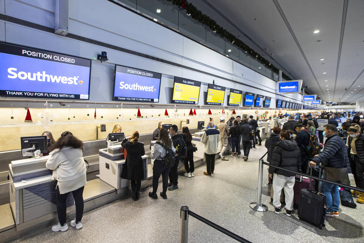 Passengers check-in at Southwest Airlines at Harry Reid International Airport on Thursday, Dec. ...