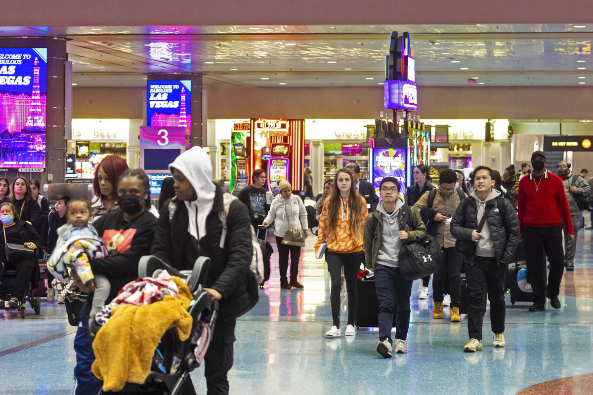 Arriving passengers walk through baggage claim at Harry Reid International Airport on Thursday, ...