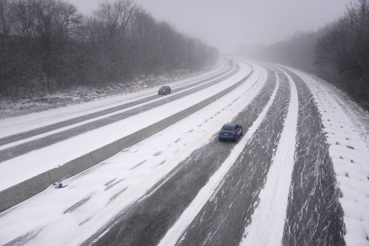 Vehicles travel along Interstate 44 as snow begins to fall and temperatures drop Thursday, Dec. ...
