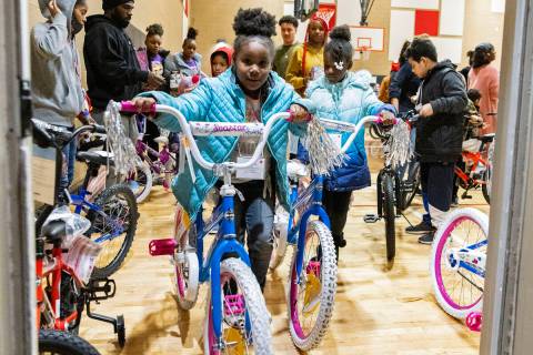 Melissa Williams, 8, left, and her cousin Naryiah Jackson, 8, push their bikes out of Pearson C ...