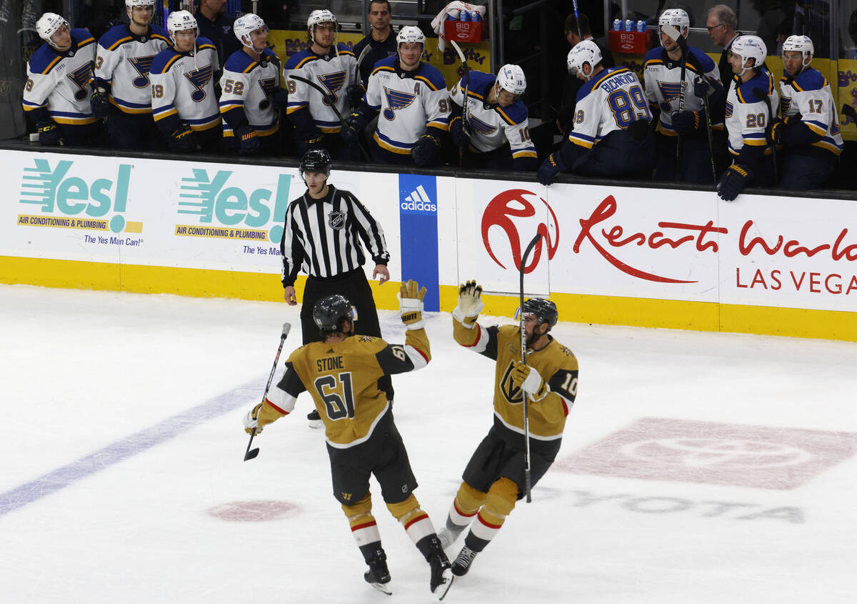 Golden Knights right wing Mark Stone (61) celebrates with Golden Knights center Nicolas Roy (10 ...
